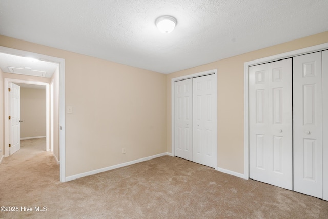 1507 Brookfield Rd, Rockingham, NC 28379 - unfurnished bedroom featuring carpet flooring, multiple closets, and a textured ceiling