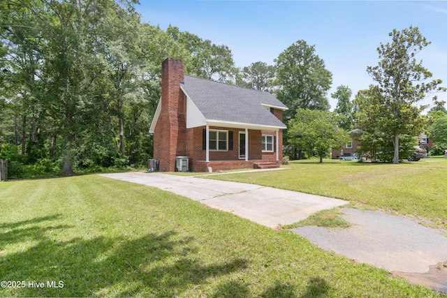 1507 Brookfield Rd, Rockingham, NC 28379 - view of front of property featuring driveway, a chimney, a front yard, brick siding, and a shingled roof