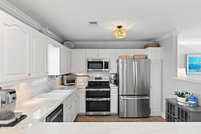 kitchen with white cabinetry, visible vents, light countertops, a sink, and stainless steel appliances