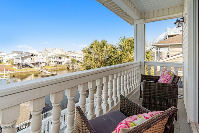 balcony featuring a water view and a residential view