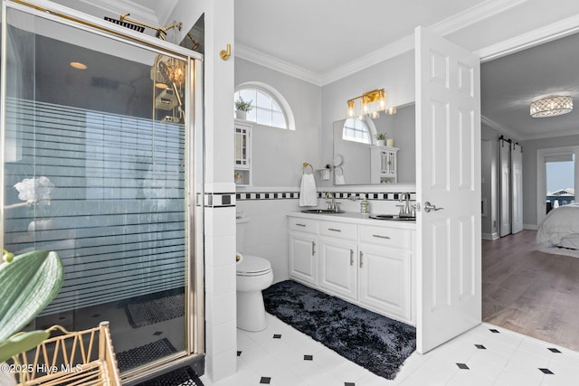 full bathroom featuring vanity, ornamental molding, a stall shower, tile patterned floors, and toilet