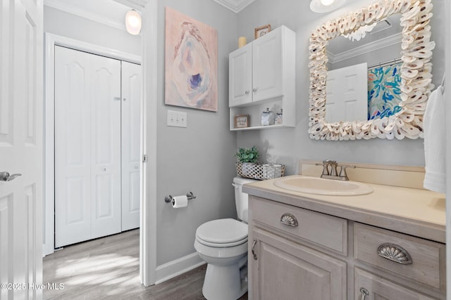 full bath with vanity, baseboards, ornamental molding, toilet, and wood finished floors