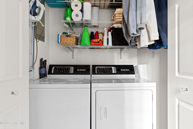 washroom featuring laundry area and washing machine and clothes dryer