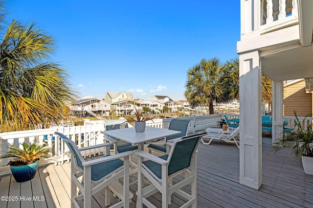 wooden deck featuring a residential view and outdoor dining area