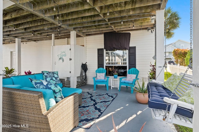 view of patio featuring outdoor lounge area and fence