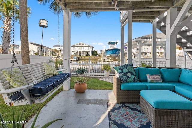 view of patio featuring a residential view, outdoor lounge area, and fence