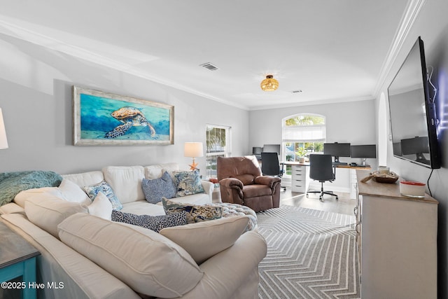 living room with visible vents, ornamental molding, and wood finished floors