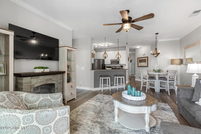 1135 Park Rd SW Unit 1203, Sunset Beach, NC 28468 - living room featuring ceiling fan, dark wood-style flooring, a fireplace, ornamental molding, and baseboards