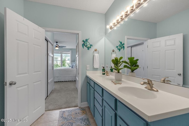 1135 Park Rd SW Unit 1203, Sunset Beach, NC 28468 - ensuite bathroom featuring double vanity, a ceiling fan, tile patterned floors, and baseboards