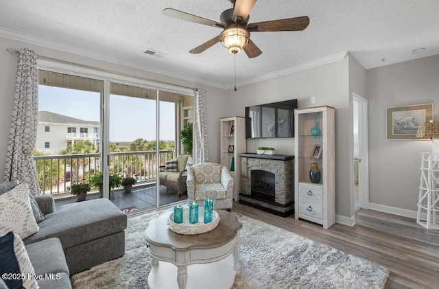 1135 Park Rd SW Unit 1203, Sunset Beach, NC 28468 - living area featuring a textured ceiling, wood finished floors, ceiling fan, crown molding, and baseboards