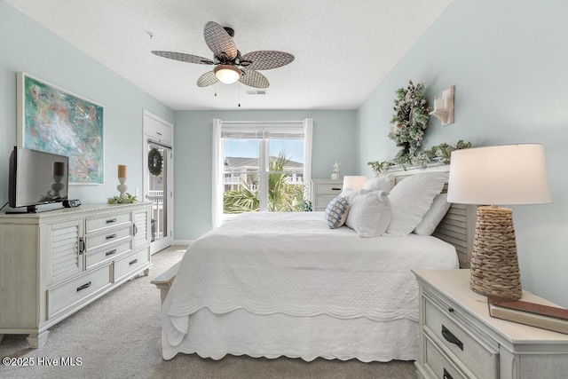 1135 Park Rd SW Unit 1203, Sunset Beach, NC 28468 - bedroom featuring a textured ceiling, light carpet, access to outside, and a ceiling fan