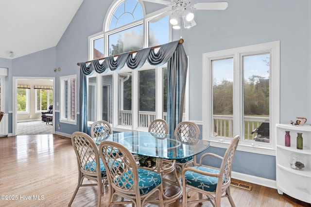 178 Edgewater Cir, Sunset Beach, NC 28468 - dining area featuring wood finished floors, high vaulted ceiling, ceiling fan, and baseboards