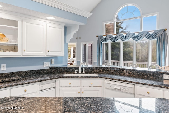 178 Edgewater Cir, Sunset Beach, NC 28468 - kitchen with white cabinets, white dishwasher, a sink, dark stone counters, and vaulted ceiling