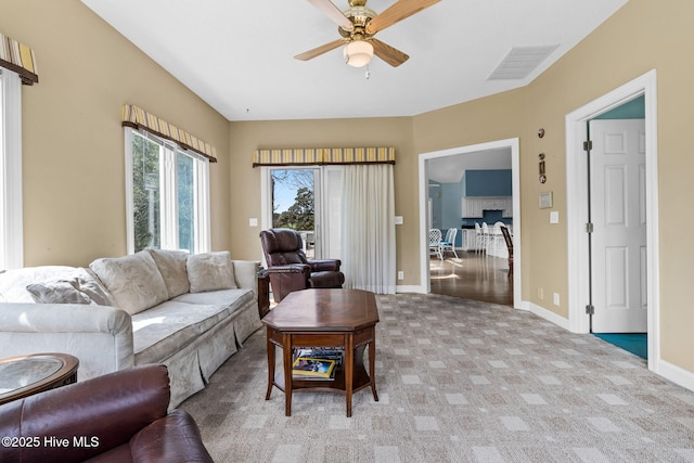 178 Edgewater Cir, Sunset Beach, NC 28468 - living room featuring light colored carpet, baseboards, a ceiling fan, and visible vents