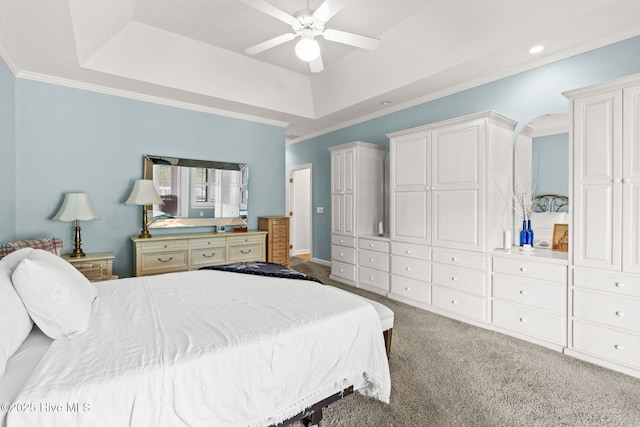 178 Edgewater Cir, Sunset Beach, NC 28468 - carpeted bedroom featuring arched walkways, ceiling fan, ornamental molding, and a raised ceiling