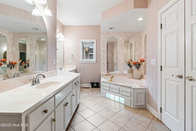 178 Edgewater Cir, Sunset Beach, NC 28468 - bathroom featuring tile patterned floors, vanity, a garden tub, and wallpapered walls