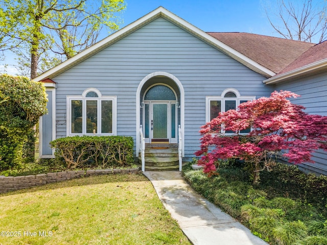 178 Edgewater Cir, Sunset Beach, NC 28468 - view of front of home with roof with shingles and a front lawn