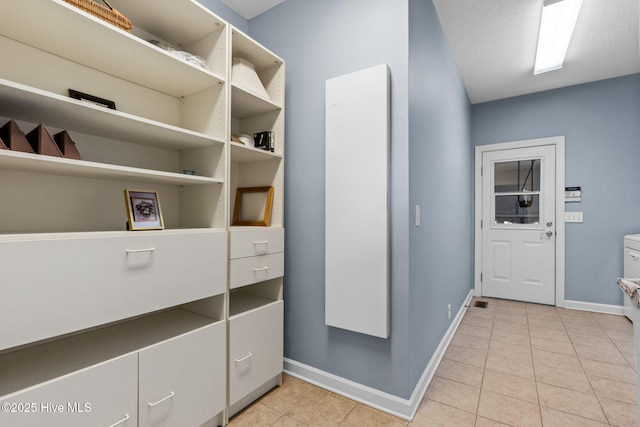 178 Edgewater Cir, Sunset Beach, NC 28468 - interior space with a textured ceiling, light tile patterned floors, and baseboards
