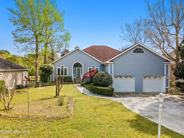 178 Edgewater Cir, Sunset Beach, NC 28468 - view of front facade featuring a front yard, a garage, and concrete driveway
