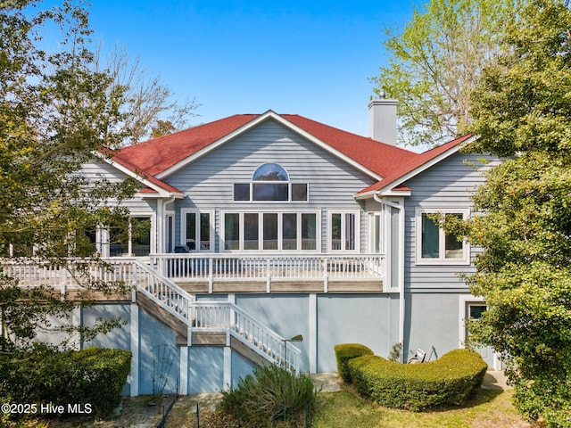 178 Edgewater Cir, Sunset Beach, NC 28468 - rear view of property with stairway and a chimney