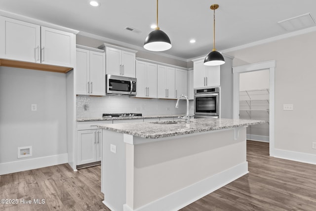 804 Winds Way, Aberdeen, NC 28315 - kitchen featuring appliances with stainless steel finishes, crown molding, recessed lighting, tasteful backsplash, and wood finished floors