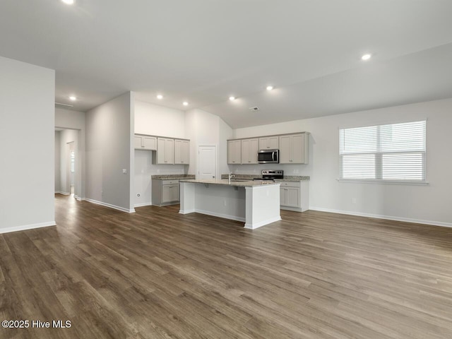 113 Legare St Lot 254, Wilmington, NC 28411 - kitchen with stainless steel microwave, range with electric cooktop, open floor plan, a kitchen island with sink, and wood finished floors