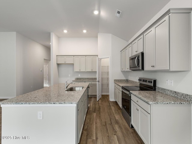 113 Legare St Lot 254, Wilmington, NC 28411 - kitchen featuring stainless steel appliances, dark wood finished floors, recessed lighting, an island with sink, and light stone countertops