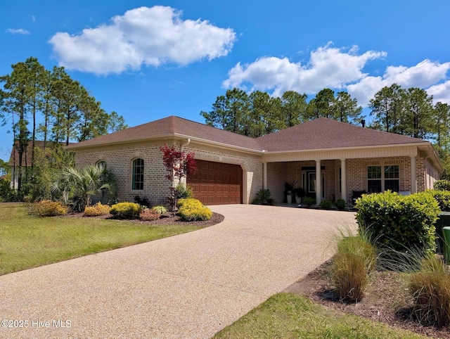 ranch-style home featuring brick siding, driveway, a front lawn, and a garage