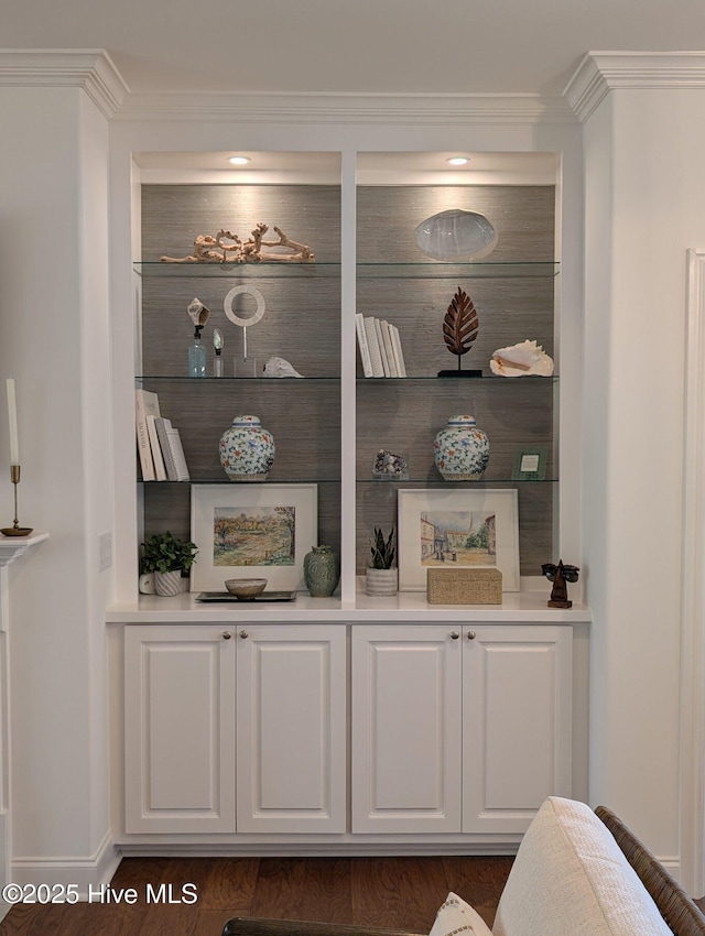room details featuring wood finished floors, baseboards, and ornamental molding