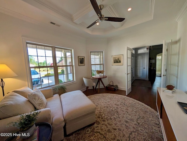 living area featuring dark wood-style floors, coffered ceiling, visible vents, a ceiling fan, and ornamental molding
