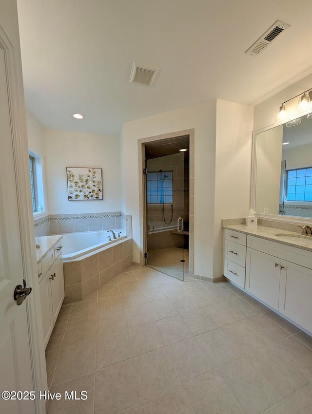 bathroom featuring a garden tub, visible vents, tile patterned flooring, and a stall shower
