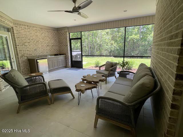sunroom featuring ceiling fan and an outdoor hangout area