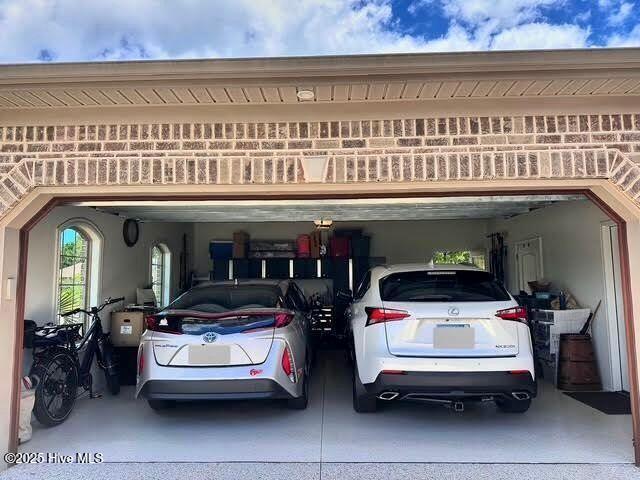 view of parking with a garage and concrete driveway
