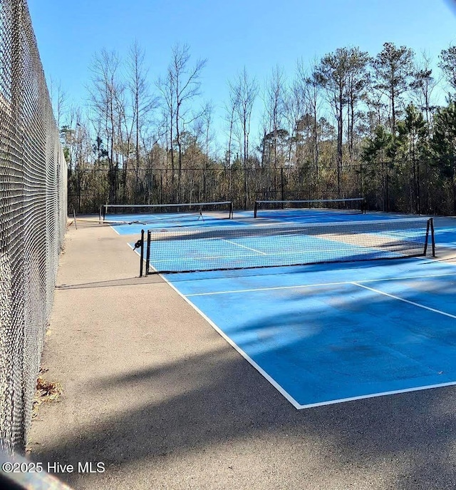view of tennis court featuring fence