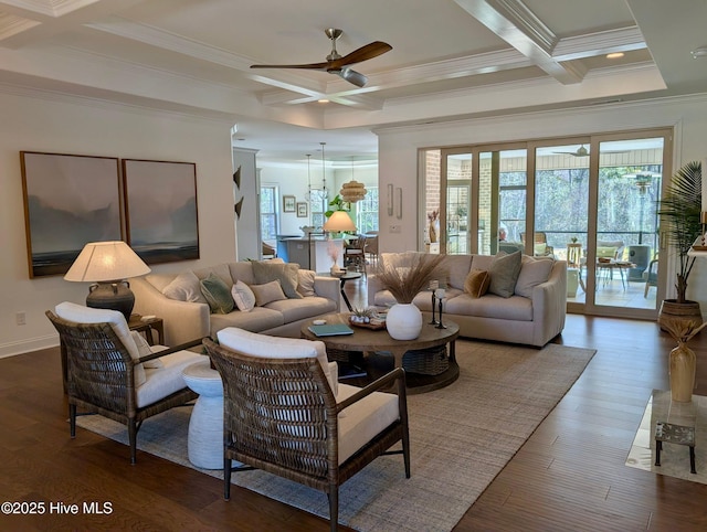 living area with ceiling fan, a wealth of natural light, coffered ceiling, and crown molding