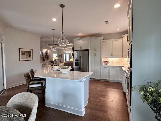 kitchen featuring recessed lighting, crown molding, stainless steel appliances, and light countertops