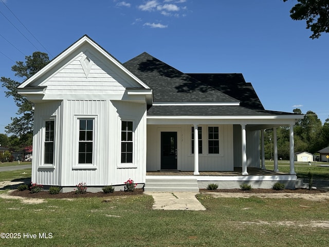 212 N Hill St, Faison, NC 28341 - modern farmhouse with board and batten siding, roof with shingles, a front lawn, and covered porch