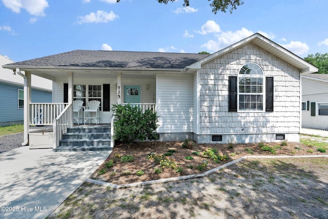 115 NE 29th St, Oak Island, NC 28465 - view of front of home featuring a porch, roof with shingles, and crawl space