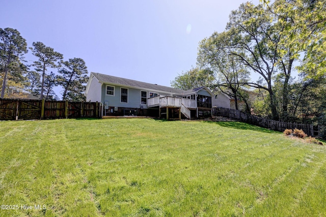 view of yard with stairway, a fenced backyard, and a deck