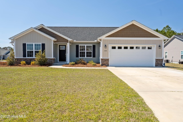 330 Independence Blvd, Newport, NC 28570 - craftsman inspired home with board and batten siding, driveway, an attached garage, stone siding, and a front lawn