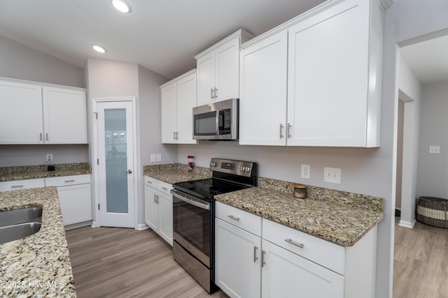 330 Independence Blvd, Newport, NC 28570 - kitchen featuring light stone counters, recessed lighting, light wood finished floors, white cabinets, and appliances with stainless steel finishes