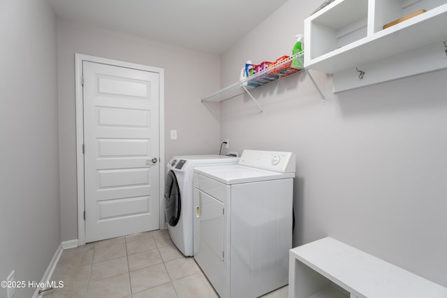 330 Independence Blvd, Newport, NC 28570 - laundry room featuring washing machine and clothes dryer, baseboards, laundry area, and light tile patterned flooring