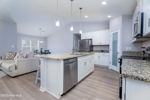 330 Independence Blvd, Newport, NC 28570 - kitchen with a sink, vaulted ceiling, light wood-style flooring, open floor plan, and appliances with stainless steel finishes