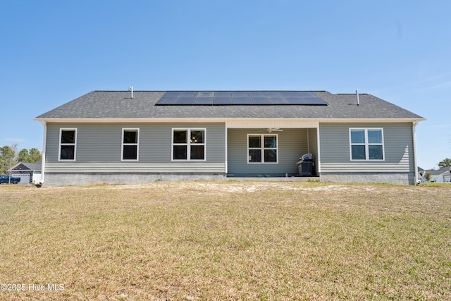 330 Independence Blvd, Newport, NC 28570 - rear view of property featuring a shingled roof, solar panels, and a lawn