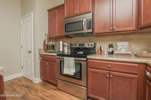 202 Peggys Trce, Sneads Ferry, NC 28460 - kitchen with tasteful backsplash, wood finished floors, appliances with stainless steel finishes, baseboards, and a toaster