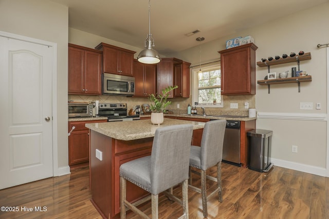 202 Peggys Trce, Sneads Ferry, NC 28460 - kitchen with stainless steel appliances, dark wood finished floors, backsplash, hanging light fixtures, and visible vents