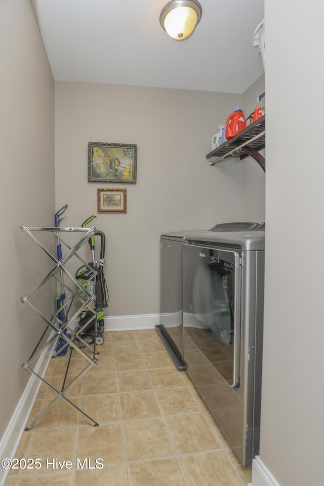 202 Peggys Trce, Sneads Ferry, NC 28460 - clothes washing area featuring baseboards, light tile patterned floors, laundry area, and washer and clothes dryer