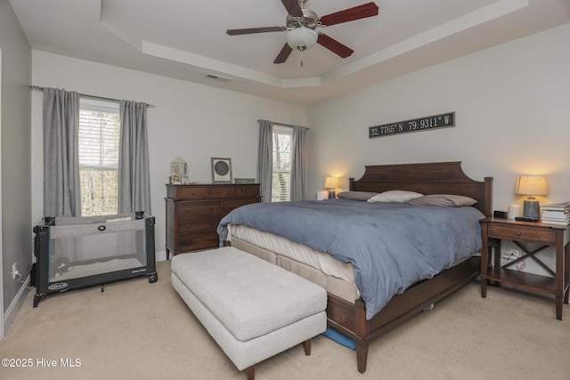 202 Peggys Trce, Sneads Ferry, NC 28460 - bedroom featuring a tray ceiling, visible vents, ceiling fan, and light colored carpet