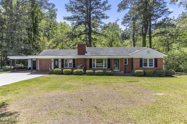 ranch-style home with a front lawn, an attached carport, a chimney, concrete driveway, and brick siding