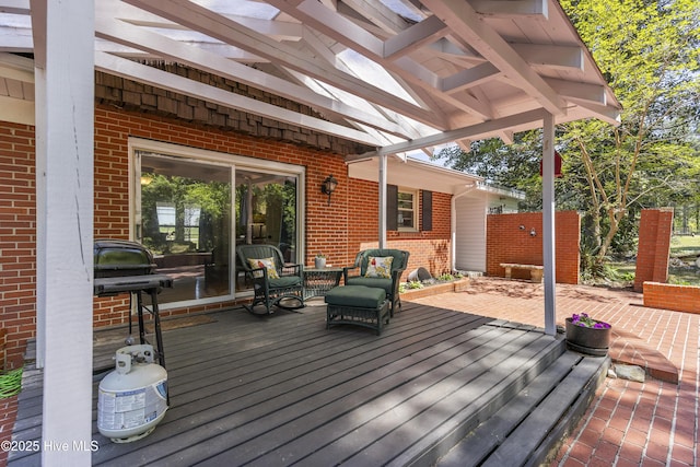 wooden deck featuring a pergola and a patio area